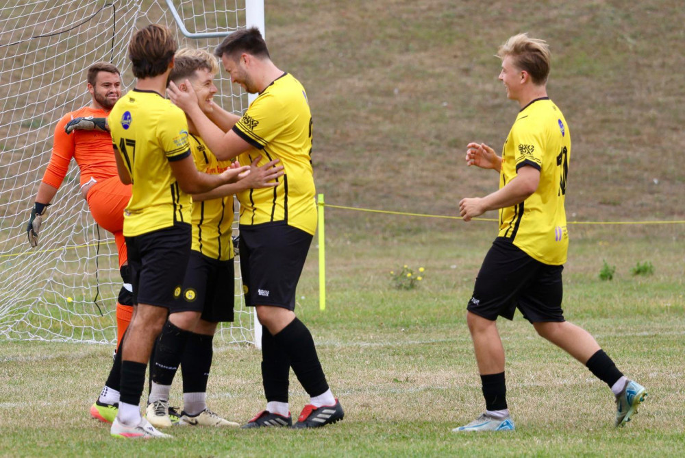 Harry Prince is congratualted after the opening goal. Picture by Vic Evans.
