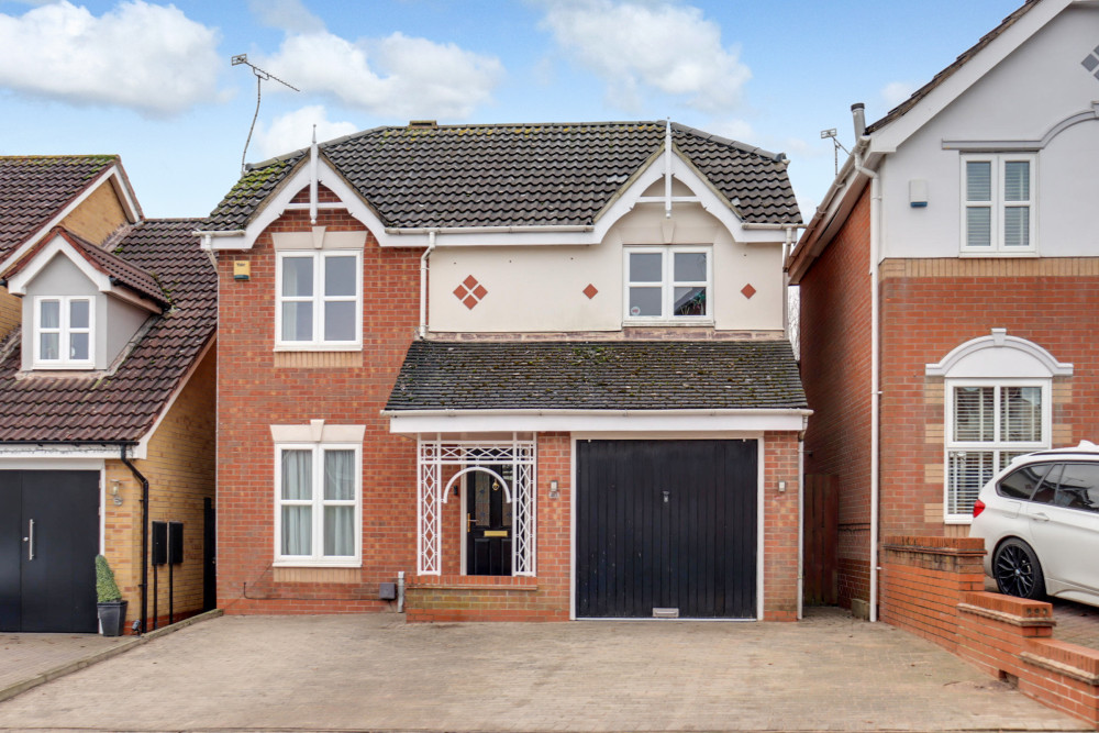 A smartly presented four-bedroom detached home with driveway parking and an attached single garage