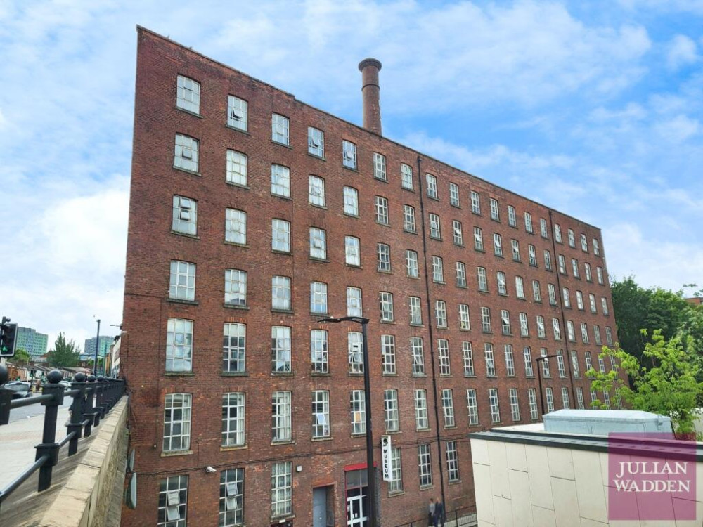 Our friends and sponsors at Julian Wadden present their property of the week - this spacious apartment in the historic Wellington Mill in Stockport town centre (Image - Julian Wadden)